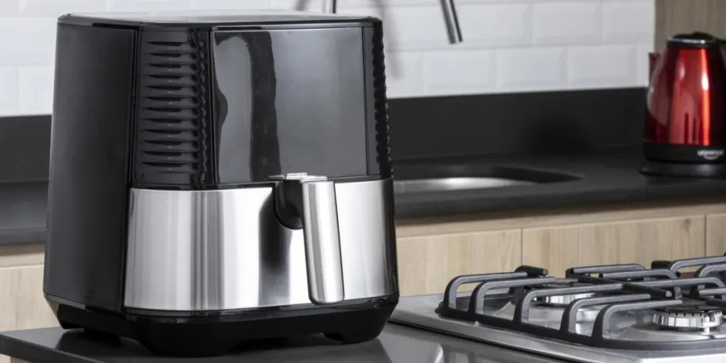 Air fryer in black on a brown kitchen counter
