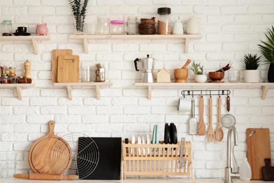 Rustic kitchen interior with white brick walls and white wooden shelves